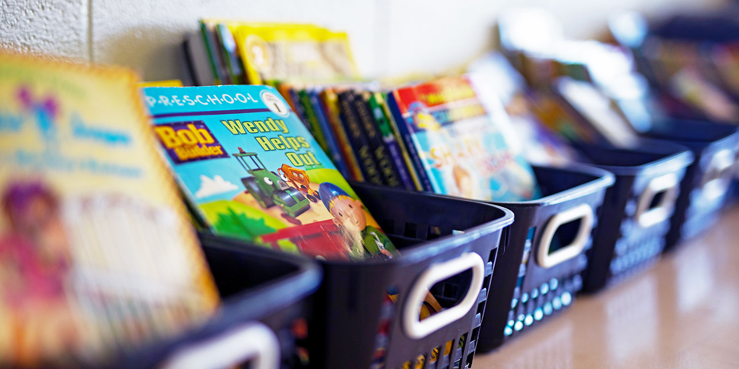 Book baskets on a classroom shelf.